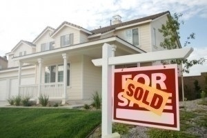 Sold Home For Sale Sign in Front of Beautiful New House.