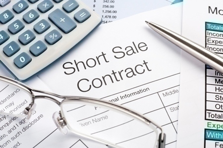 Short sale contract Form with pen, calculator