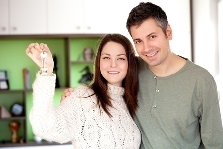 Happy young couple moving into a new home