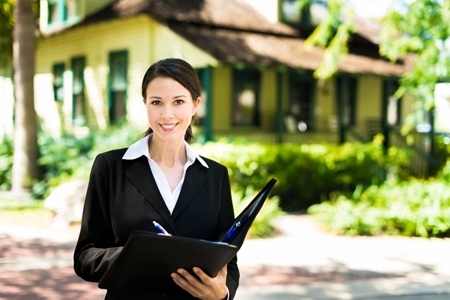 Young Businesswoman Real Estate Agent in Front of Home