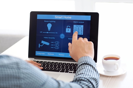 man sitting at a laptop with the program smart home