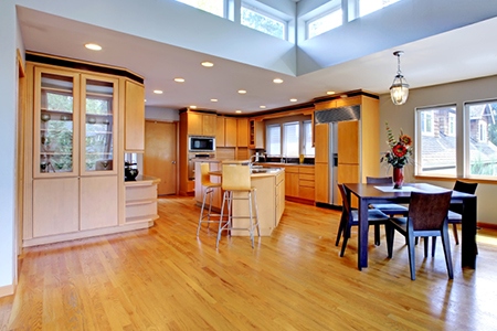 Large luxury modern wood kitchen with granite counter tops.