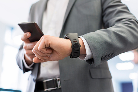 Man with Mobile phone connected to a smart watch