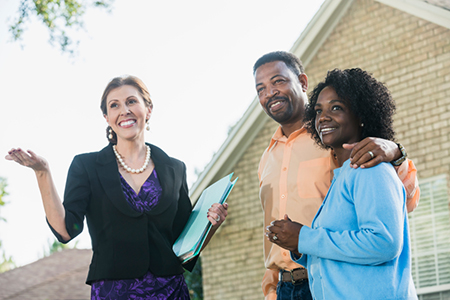 African American couple with real estate agent