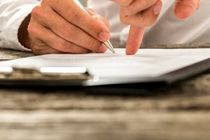 Closeup of male hand pointing where to sign a contract