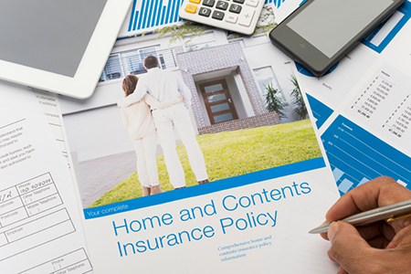 Home and contents insurance document with paperwork