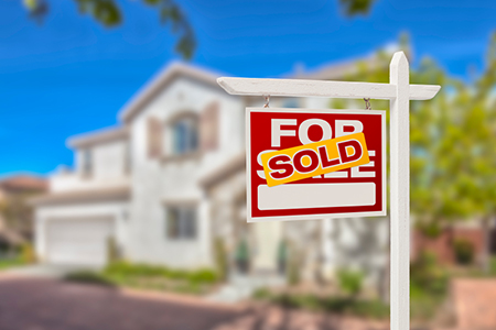 Sold Home For Sale Real Estate Sign in Front of Beautiful New House.