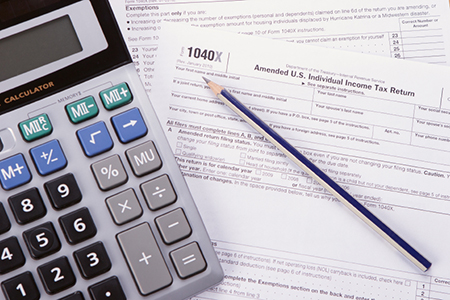 1040X individual income tax return form with calculator and penc