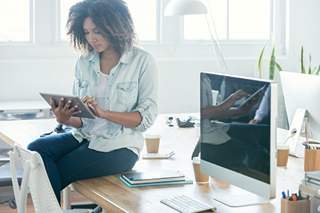 A young female businesswoman looking at her digital tablet