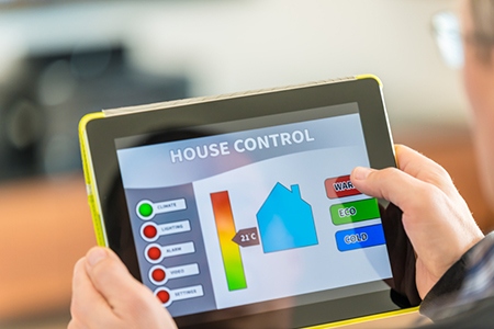 Man using digital tablet for remote house control